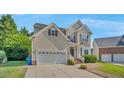 Well-maintained two-story home with neutral siding, brick steps, two-car garage and landscaped yard at 3212 Marblewood Ct, Raleigh, NC 27604