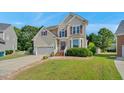 Attractive two-story home featuring brick steps, attached garage, neutral siding, and landscaped front lawn at 3212 Marblewood Ct, Raleigh, NC 27604