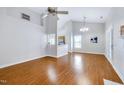 Bright, open living room with hardwood floors and high ceilings, seamlessly connecting to the kitchen area at 325 Millet Dr, Morrisville, NC 27560