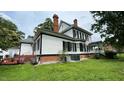Well-maintained backyard featuring a brick foundation and classic design elements at 401 N Main St, Louisburg, NC 27549
