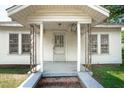 Close-up of the covered front porch, showing decorative support columns and a simple entry door at 402 at 402 Poplar St, Graham, NC 27253