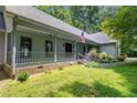 Inviting front porch with classic columns and steps leading to a well-maintained lawn at 4070 Swannie Coble Rd, Snow Camp, NC 27349