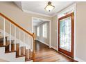 Inviting entryway boasts hardwood floors, elegant staircase, and stained glass front door at 4517 Gates St, Raleigh, NC 27609