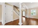 Inviting entryway boasts hardwood floors, elegant staircase, and stained glass front door at 4517 Gates St, Raleigh, NC 27609