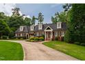Charming traditional home featuring dormer windows and a well-manicured front lawn with mature landscaping at 4517 Gates St, Raleigh, NC 27609