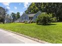 Charming blue home featuring a well-manicured front yard and inviting entrance at 5105 Baywood Forest Dr, Knightdale, NC 27545