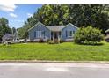 Charming blue home featuring a well-manicured front yard and inviting entrance at 5105 Baywood Forest Dr, Knightdale, NC 27545