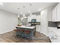 Modern kitchen featuring an island with seating and pendant lighting at 67 Little Leaf Ln # 98, Clayton, NC 27527