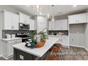 Bright kitchen with stainless steel appliances, white cabinets, and tiled backsplash at 67 Little Leaf Ln # 98, Clayton, NC 27527