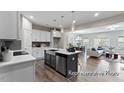 Open kitchen with an island, seamlessly flowing into the living and dining area at 67 Little Leaf Ln # 98, Clayton, NC 27527