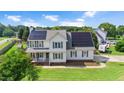 Beautiful two-story home featuring solar panels and a well-maintained lawn in a Gathering-friendly neighborhood at 73 Lynnville Ct, Lillington, NC 27546
