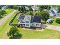 Spacious home with solar panels, fenced yard, playground, and convenient circular driveway at 73 Lynnville Ct, Lillington, NC 27546