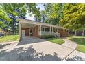 Lovely brick home with an attached carport and manicured landscaping at 908 Clarion Dr, Durham, NC 27705