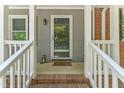 Close-up of the front porch with a decorative door and 'wipe your paws' welcome mat at 908 Clarion Dr, Durham, NC 27705