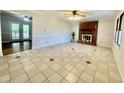 Bright living room featuring tile floors, a brick fireplace, and doors leading to an outdoor space at 101 Creekside Dr, Selma, NC 27576