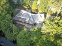 Aerial view showcases a home with lush landscaping, serene pond, and ample space for outdoor living at 101 Painted Rock Ct, Garner, NC 27529