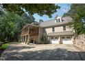 Stately brick home featuring a screened porch, attached garage, and a spacious driveway, ideal for gatherings at 101 Painted Rock Ct, Garner, NC 27529