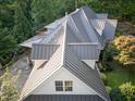 Close aerial of a luxury home showcasing a new metal roof at 101 Painted Rock Ct, Garner, NC 27529
