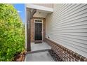 Inviting front entrance with a dark door, brick accents, and neat landscaping at 1022 Homecoming Way, Durham, NC 27703