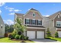 Two-story home with a two-car garage, complemented by a well-maintained lawn and landscaping at 1022 Homecoming Way, Durham, NC 27703