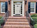 Inviting front entrance with brick steps and classic architectural details at 105 Abbotsford Ct, Durham, NC 27712