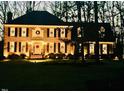 Festive brick home adorned with wreaths, creating a warm and welcoming atmosphere at 105 Abbotsford Ct, Durham, NC 27712
