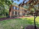 Elegant brick home featuring well-maintained landscaping and a charming front yard at 105 Abbotsford Ct, Durham, NC 27712