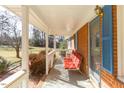 Spacious covered front porch with ample seating, offering a comfortable outdoor living space at 1186 Dick Holeman Rd, Timberlake, NC 27583
