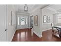 Bright foyer boasts hardwood floors, a tray ceiling, and clear view to dining room at 120 Silver Bluff St, Holly Springs, NC 27540