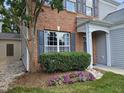 A well-maintained lawn and landscaping add charm to the brick and siding home at 121 Brentfield Loop, Morrisville, NC 27560