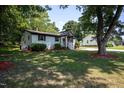 Well-maintained home exterior with a lush green lawn and mature trees, creating a serene and inviting atmosphere at 1344 Highland Dr, Wake Forest, NC 27587