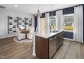 Open-concept kitchen with stainless steel appliances, a granite island, and adjacent dining area, perfect for entertaining at 1516 Tamarisk Ln, Durham, NC 27703