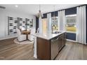 An eat-in kitchen is bright with a large island, stainless appliances and backyard views at 1527 Tamarisk Ln, Durham, NC 27703
