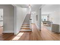Bright foyer with hardwood floors, staircase, and views of the living room, providing a welcoming entrance to the home at 1600 Pineview St, Raleigh, NC 27608