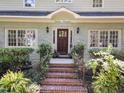 Inviting brick front steps lead to a beautiful wood front door at 1600 Pineview St, Raleigh, NC 27608