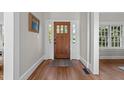 Inviting front entrance featuring a solid wood door with decorative glass and sidelights, hardwood floors, and neutral decor at 1600 Pineview St, Raleigh, NC 27608