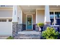 Charming front porch with stone accents and a blue door at 1880 Woodall Crest Dr, Apex, NC 27502