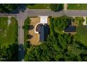 Birds eye view of a new home with a black metal roof and surrounding foliage at 205 Gentry St, Roxboro, NC 27573