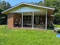 Welcoming front porch with brick accents, offering a cozy outdoor space with potential for customization at 2306 Cool Springs Rd, Sanford, NC 27330
