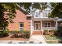 Charming two-story home featuring a brick and siding exterior, a front porch, and well-maintained landscaping at 2613 Sweet Gum Dr, Hillsborough, NC 27278