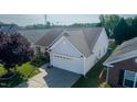 An elevated view of the home's roof, two-car garage, and backyard at 326 Slate Dr, Gibsonville, NC 27249