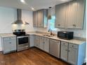 Modern kitchen featuring stainless steel appliances, granite countertops, and gray cabinetry at 331 E Lillington St, Angier, NC 27501