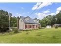 Charming home featuring red shutters, a well-manicured lawn, an American flag, and a chimney at 3573 Northern Estates Cir, Rocky Mount, NC 27804