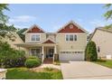 Inviting two-story home featuring a charming front porch and a convenient two-car garage at 3806 Stoneybrook Dr, Durham, NC 27705