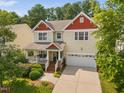 Inviting two-story home featuring a charming front porch and a convenient two-car garage at 3806 Stoneybrook Dr, Durham, NC 27705