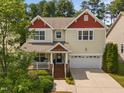 Inviting two-story home featuring a charming front porch and a convenient two-car garage at 3806 Stoneybrook Dr, Durham, NC 27705