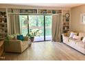 Bright living room with hardwood floors, built-in bookshelves and sliding door to the patio at 500 Umstead Dr # D307, Chapel Hill, NC 27516