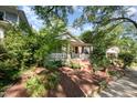 Quaint home featuring a brick staircase leading up to a covered porch with curtains for added privacy at 513 Cutler St, Raleigh, NC 27603