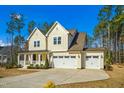 Lovely two-story home with a front porch and three-car garage, nestled in a landscaped yard at 5148 Glen Creek Trl, Garner, NC 27529