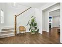 Bright foyer featuring hardwood floors, stairs, and a view into an adjacent living space at 5148 Glen Creek Trl, Garner, NC 27529